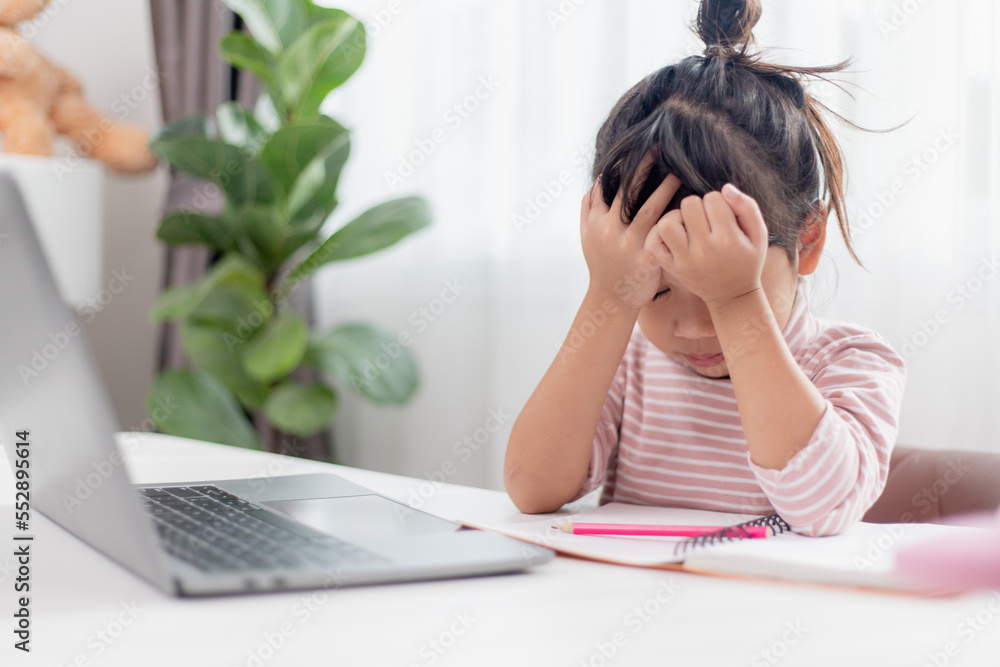 Asian child is serious about studying homework during online lesson at home, social distancing during quarantine, self-isolation, online education concept, homeschooling, Asian child is serious about studying homework during online lesson at home, social distancing during quarantine, self-isolation, online education concept, homeschooling,