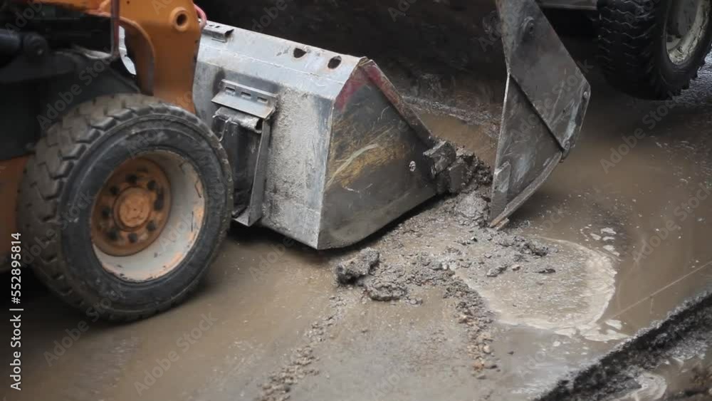 Bulldozer at a construction site. Heavy equipment at work. Bulldozer bucket on the asphalt. Bulldozer at a construction site. Heavy equipment at work. Bulldozer bucket on the asphalt.
