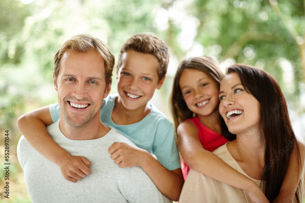 Making happy memories together. Portrait of a happy family of four spending time together outdoors. Making happy memories together. Portrait of a happy family of four spending time together outdoors.