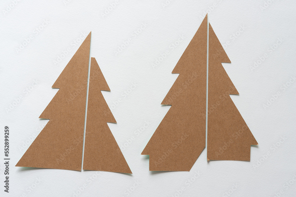 two plain brown paper christmas trees on blank paper
