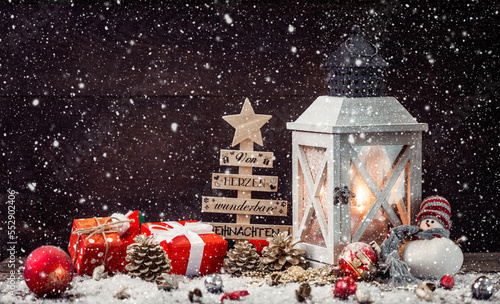 Christmas Lantern on snowy table with festive decoration.
