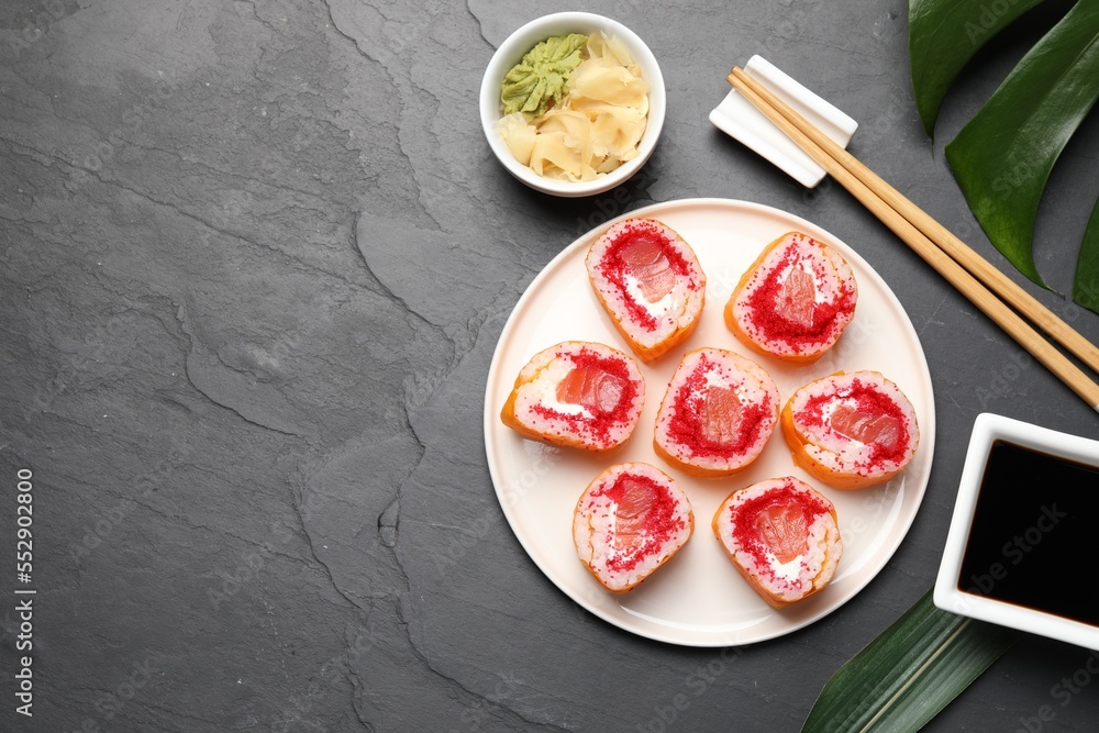 Flat lay composition with sushi rolls on black textured table. Space for text Flat lay composition with sushi rolls on black textured table. Space for text