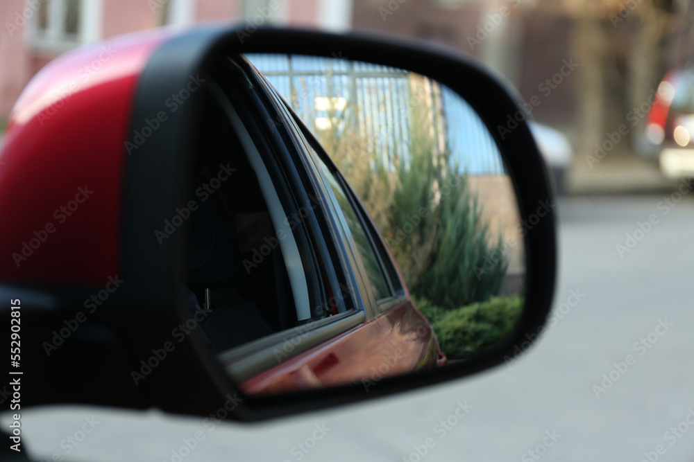 Side rear view mirror of modern car outdoors, closeup