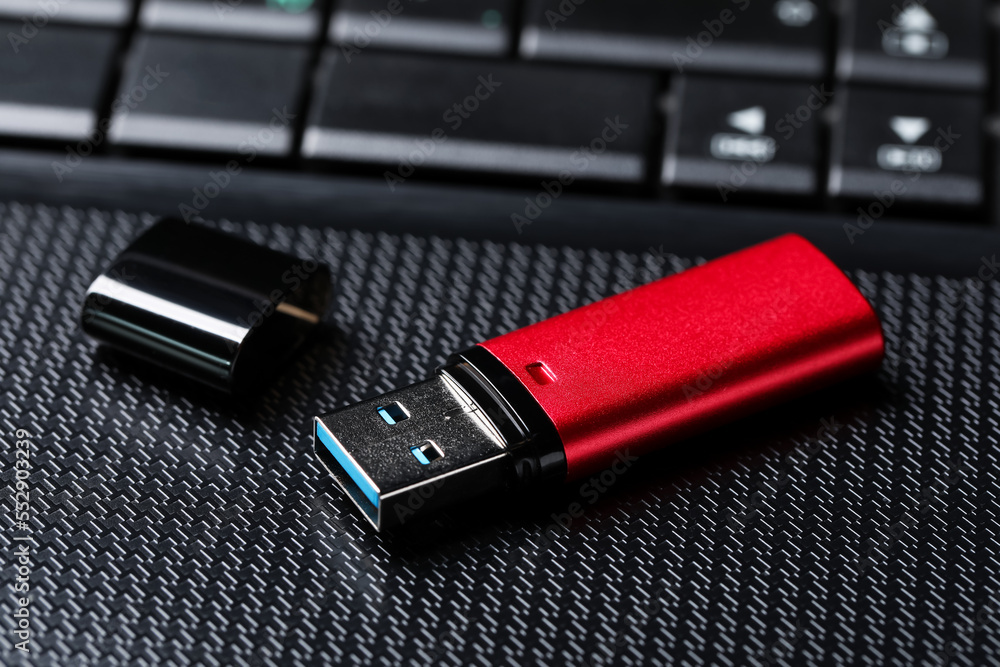 Modern usb flash drive on laptop, closeup Modern usb flash drive on laptop, closeup