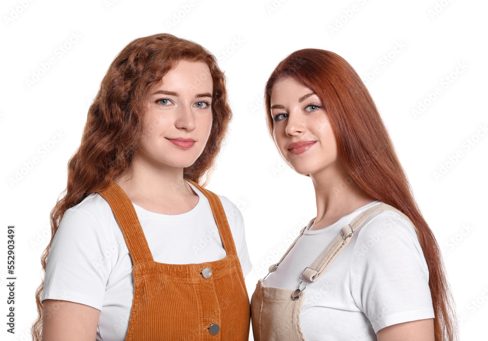Portrait of beautiful young redhead sisters on white background Portrait of beautiful young redhead sisters on white background