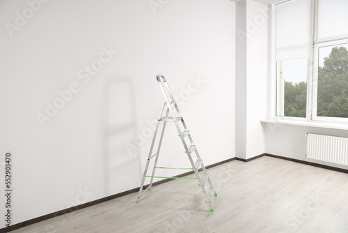 Stepladder near white wall in empty room