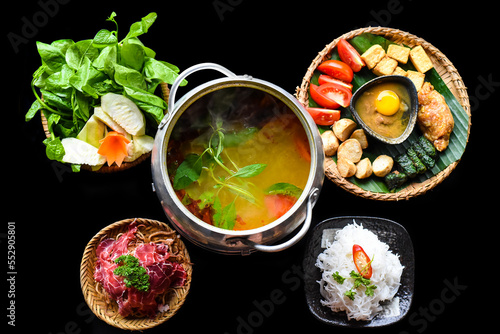 Korean spicy hot pot with beef meat and noodles on black background