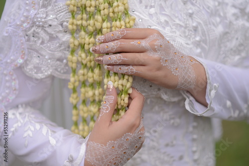 jasmine flowers use as decoration on indonesian wedding, holding by bride hands