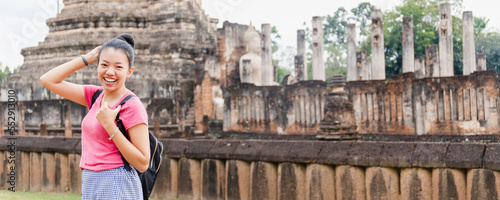 Asian woman tourists are traveling in old temple Thai architecture at Sukhothai, Thailand.The ancient city that had been abandoned in the past of Thai history.