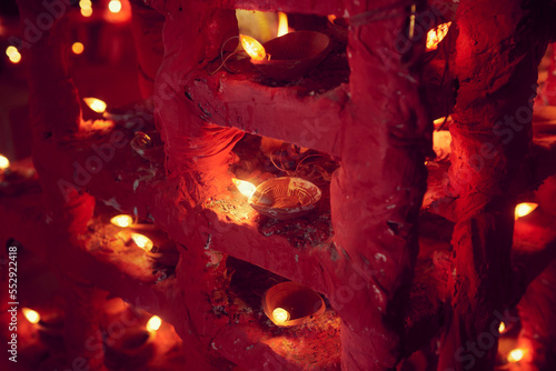 Illuminated led lights on earthen diyas creating a dramatic atmosphere inside a themed Jagaddhatri puja pandal at Chandannagar, where it is a major hindu religious festival. photo