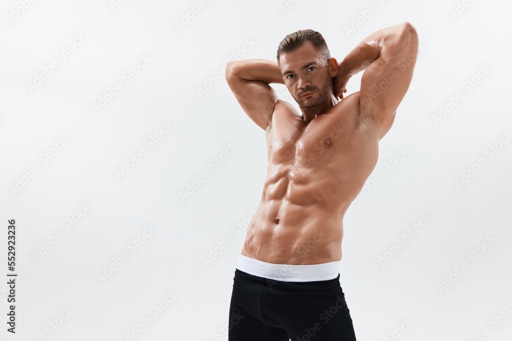 Man athletic body bodybuilder in briefs with naked torso abs full-length in the background, fitness classes. Advertising, sports, active lifestyle, competition, challenge concept. Man athletic body bodybuilder in briefs with naked torso abs full-length in the background, fitness classes. Advertising, sports, active lifestyle, competition, challenge concept.