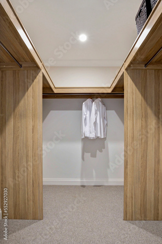 new  stylish modern Walk in robe with two white business shirts hanging 