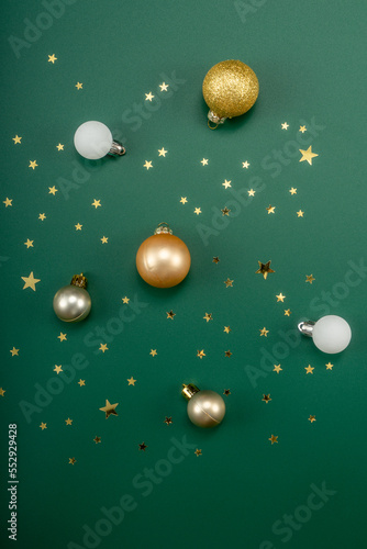 Fototapeta Naklejka Na Ścianę i Meble -  Christmas composition. Christmas ball and stars on green background.