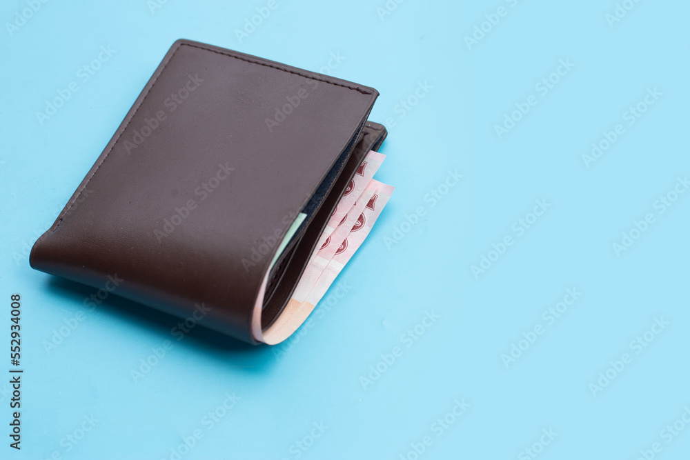 Brown wallet on blue background Brown wallet on blue background