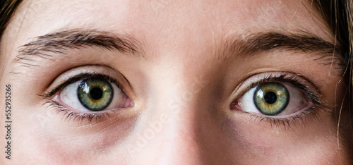 Close-up of beautiful green eyes of a woman