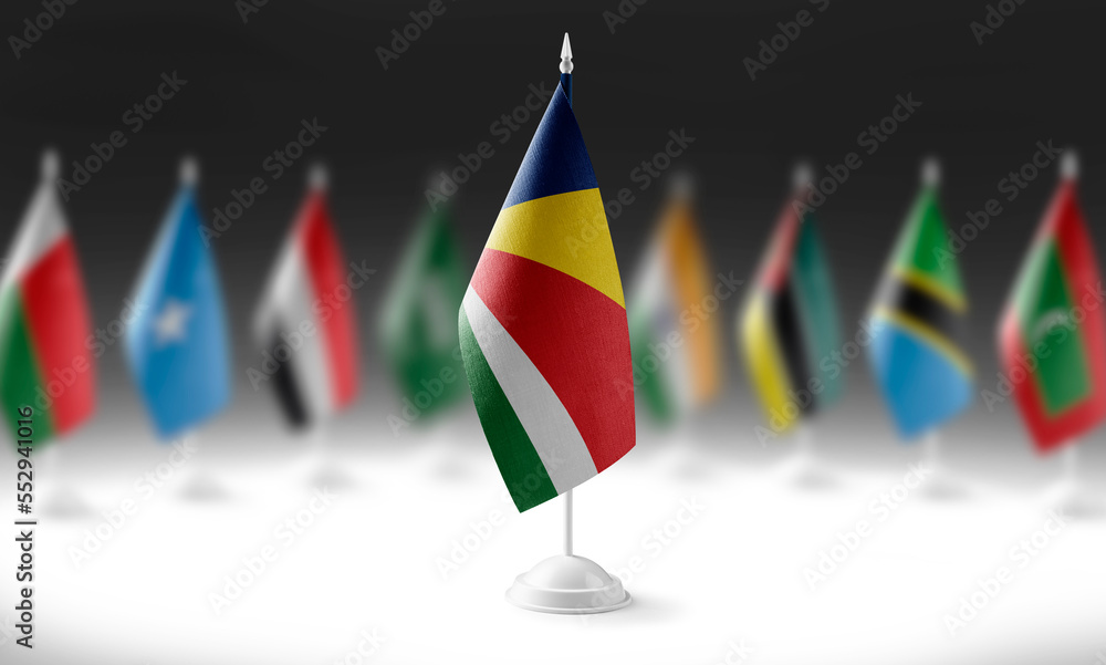 The national flag of the Seychelles on the background of flags of other countries The national flag of the Seychelles on the background of flags of other countries