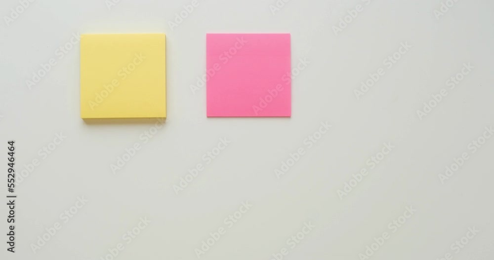 Six multi-colored stacks of note paper on a white background. Looped 4K stop motion animation Six multi-colored stacks of note paper on a white background. Looped 4K stop motion animation