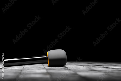 Canvas Print Microphone for an interview or reportage on floor on black background