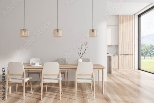 Luxury kitchen interior with eating table and cooking zone, panoramic window