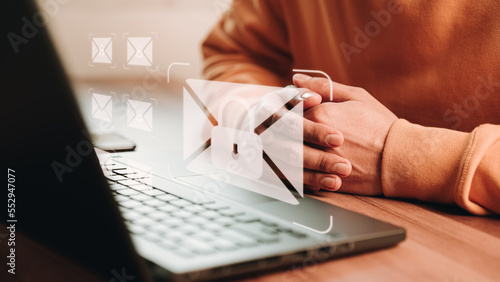 Freelancer's hand using computer laptop and sending online message with email icon, email marketing concept, send email or newsletter, internet network working online.