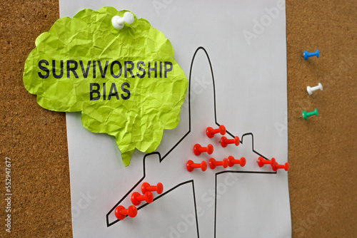 Paper brain with the inscription survivorship bias pinned to the board. photo