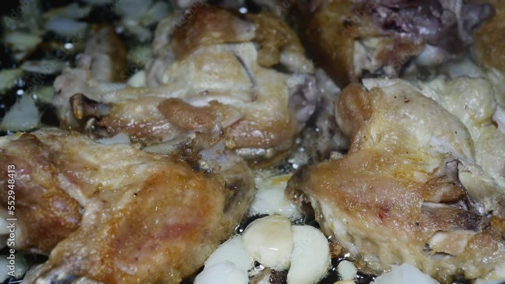 chicken wings with chopped onion and garlic fry in a pan chicken wings with chopped onion and garlic fry in a pan