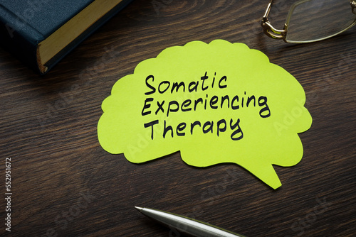 Somatic experiencing therapy sign on the page with brain shape.