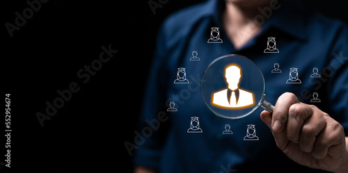 Headhunting, Recruitment and HRM all picking workers. Magnifier glass focus to manager icon which is among staff icons for human development recruitment leadership and customer target group concept.