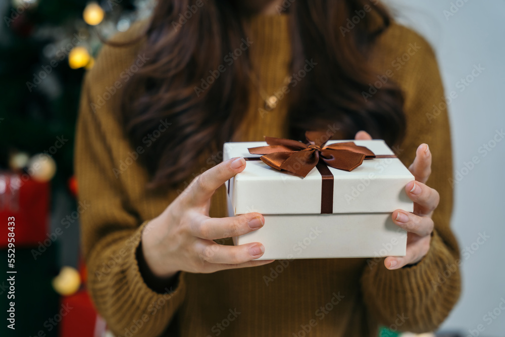 Merry Christmas, Hands opening christmas gift on background of