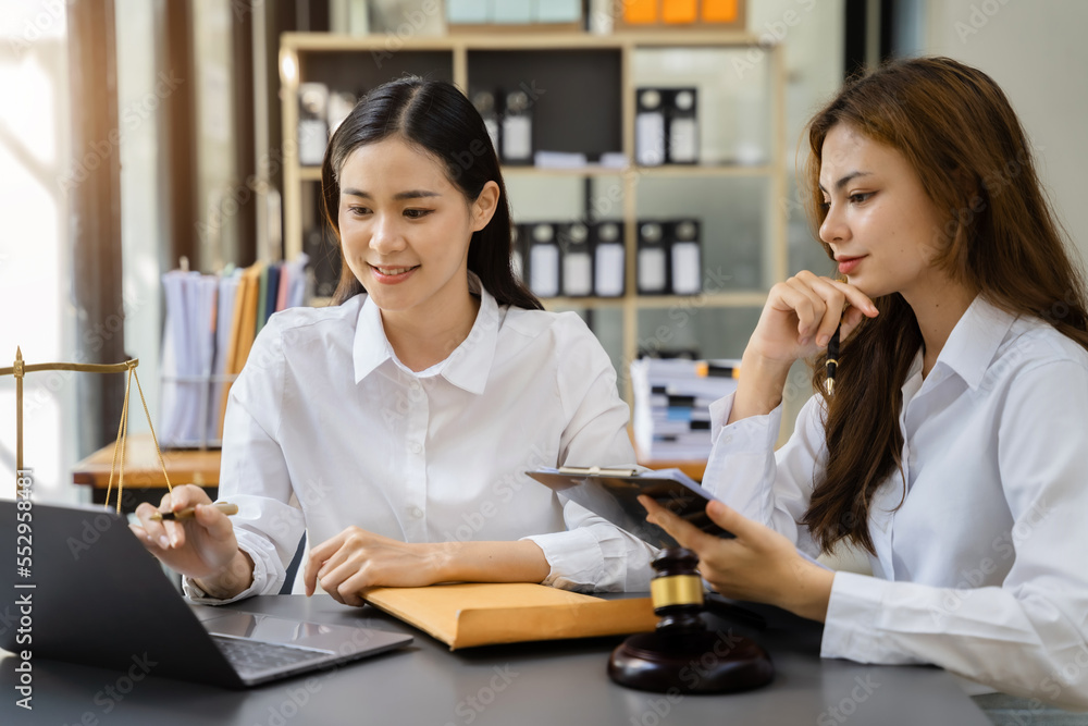 Teamwork of business lawyer meeting working hard about legal legislation in courtroom to help their customer. Teamwork of business lawyer meeting working hard about legal legislation in courtroom to help their customer.