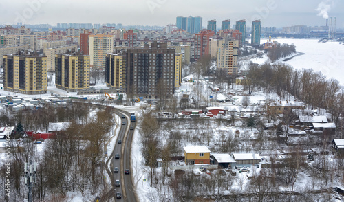 View of the residential area of the city and the Neva River from the top floor of a high-rise building.