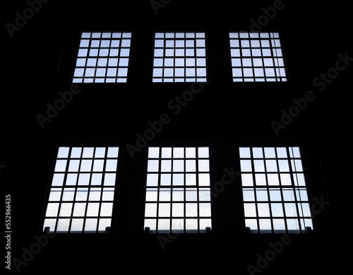 Windows in an old building with blue sky seen through windows