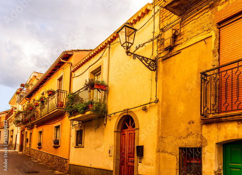 old mediterranean mountain dense town with yellow houses in evening light, vintage european village