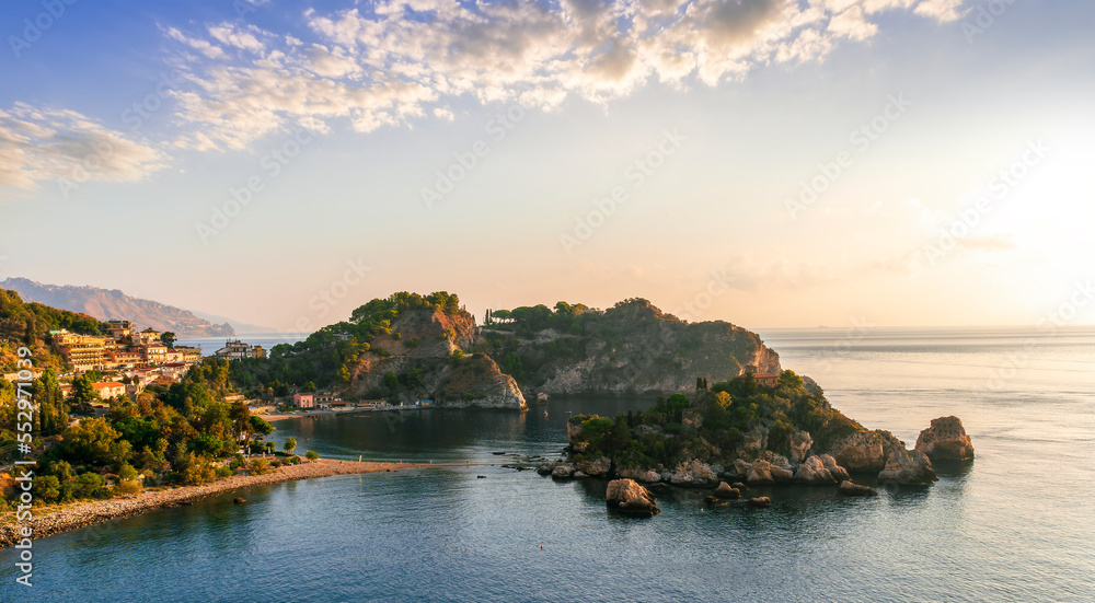 amazing view to a rocky coast and beautiful isle in sea with nice coasline and clouds on the background of the evening sea landscape