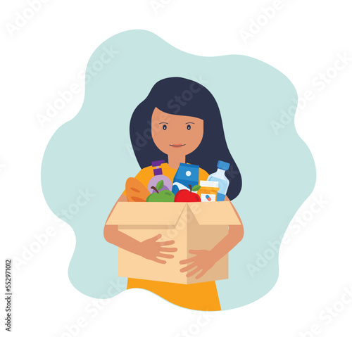 Young woman carries a box of food. Social care, volunteering and charity concept.