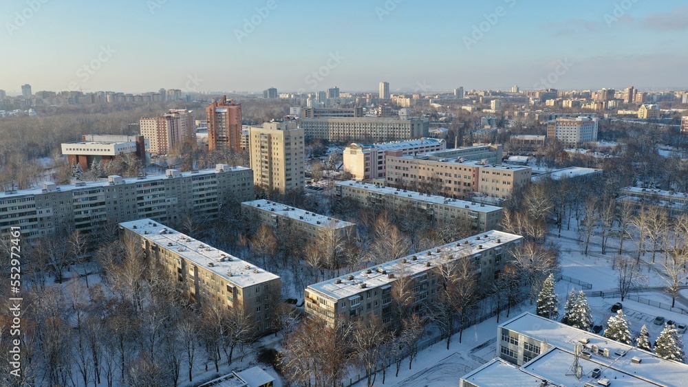 Fototapeta premium Vostok microdistrict in Minsk in winter. Sleeping areas of the capital of Belarus in the snow. Snow-covered Minsk in winter. Aerial photography of Minsk from above. Eastern Europe.