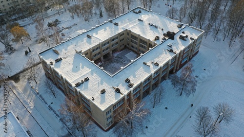Typical architecture of the Soviet school. What a school building in the USSR looks like under the snow in winter. Typical project of a school in the Soviet Union. Eastern Europe in winter under snow.