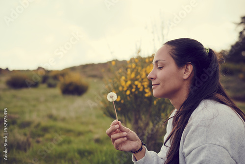 Native american woman blowing dandelion