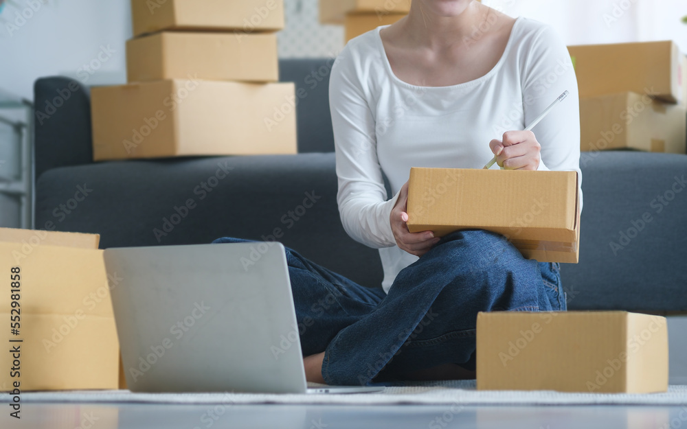 Small business entrepreneur using laptop computer, checking order from customer. Startup small business, Online selling, E-commerce concept. Small business entrepreneur using laptop computer, checking order from customer. Startup small business, Online selling, E-commerce concept.