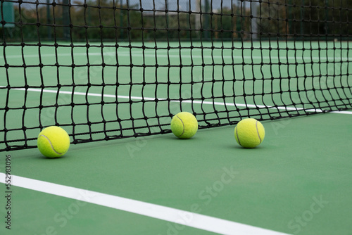 Tennis ball on green court © doganyavas