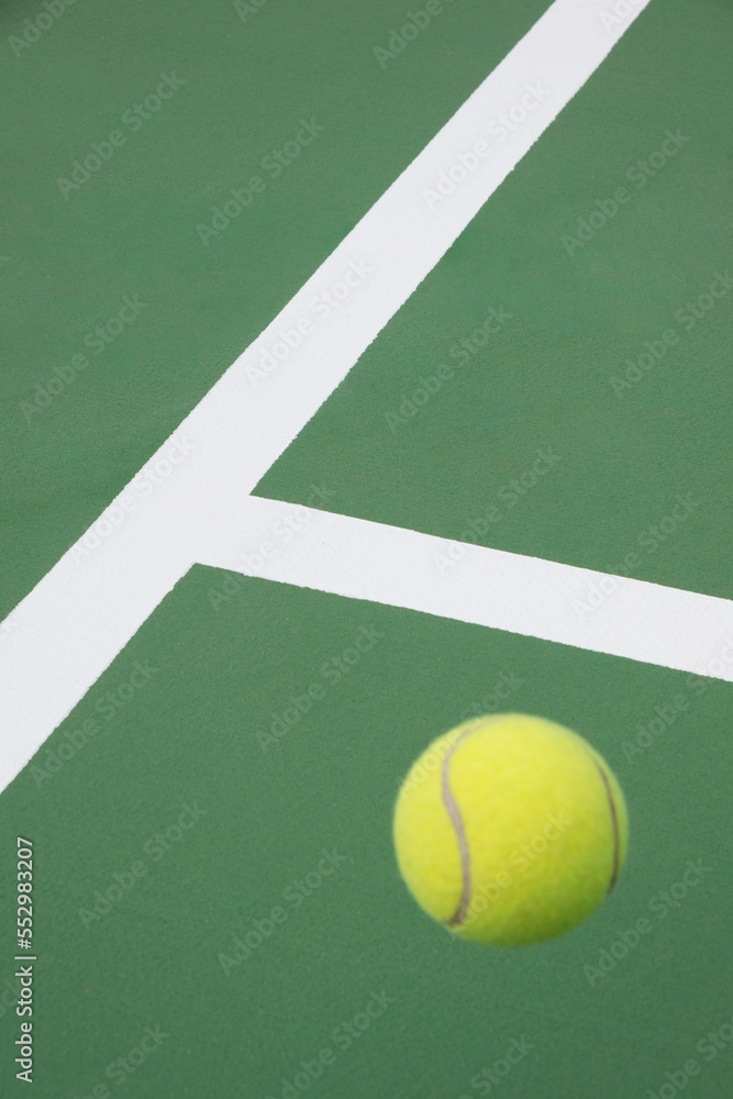 Tennis ball on green court