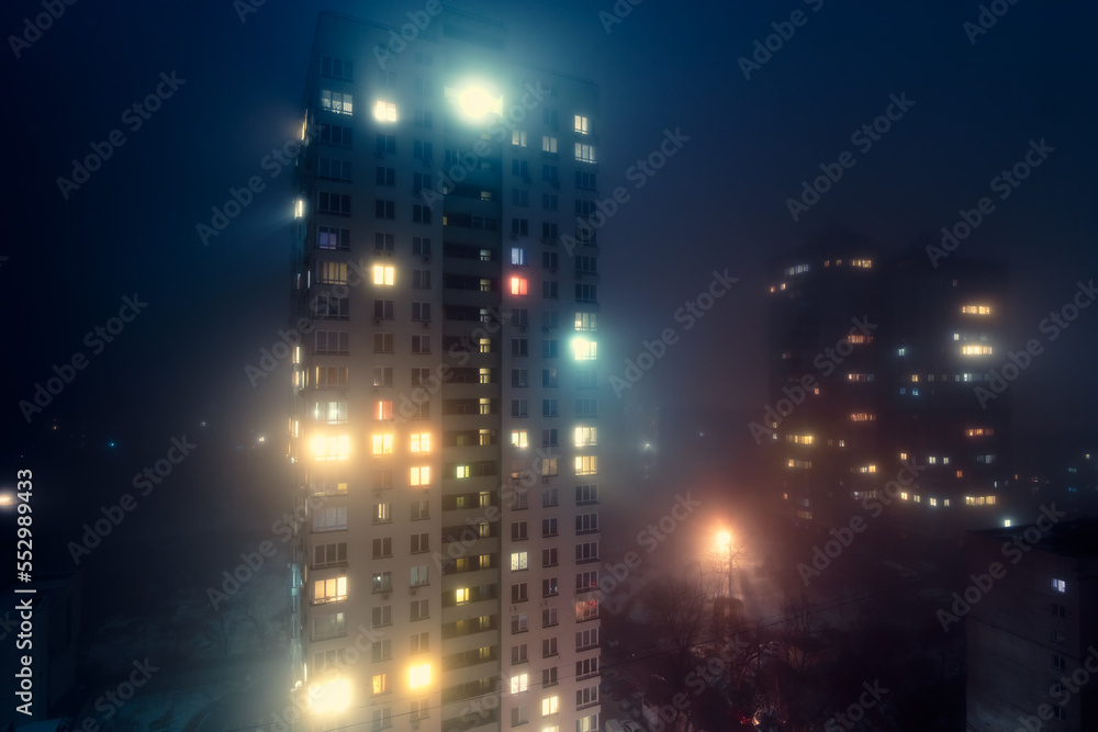 Residential building in the fog at night in Kyiv.