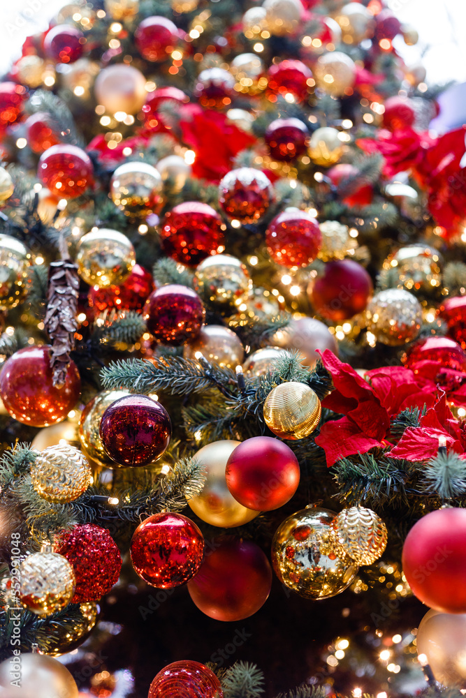 Close up of balls on christmas tree. Bokeh garlands in the background. New Year concept.