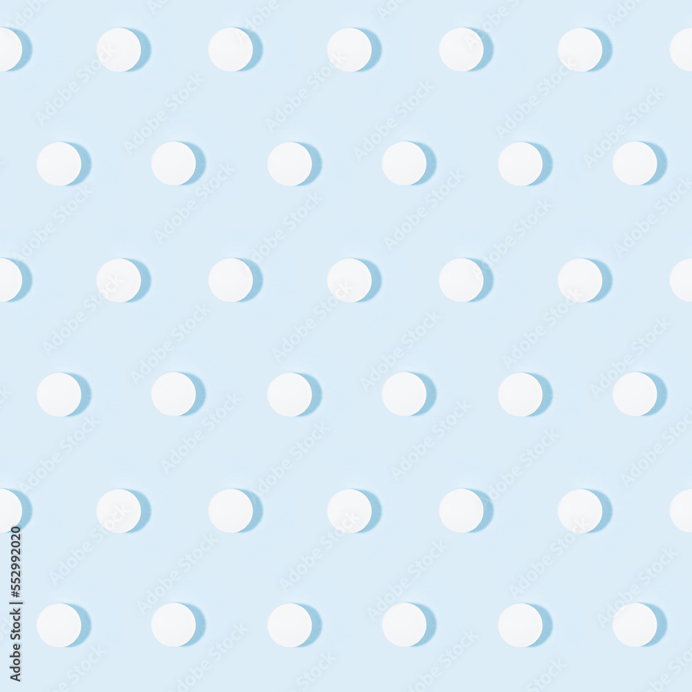 White tablets or pills seamless pattern on soft light pastel blue color in hard light with shadow, top view. Pharmacy background in simple style of medical, remedies for prevent and teraphy disease.