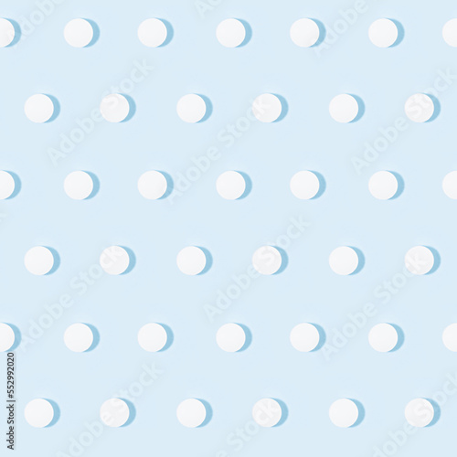 White tablets or pills seamless pattern on soft light pastel blue color in hard light with shadow, top view. Pharmacy background in simple style of medical, remedies for prevent and teraphy disease.