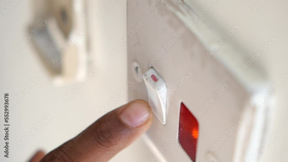 A finger turning on lighting switch . A finger turning on lighting switch .
