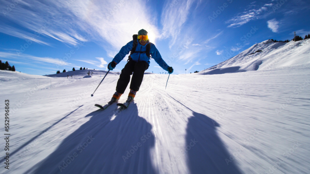 professional skier skiing on slopes in the Swiss alps towards the camera