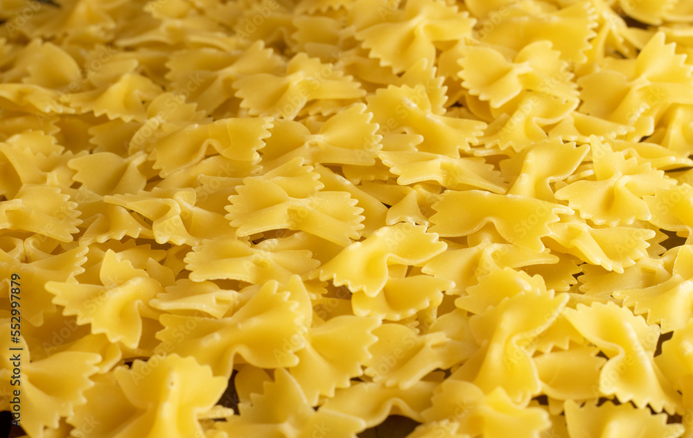 Uncooked farfalle pasta. Top view of bright background image. Uncooked farfalle pasta. Top view of bright background image.