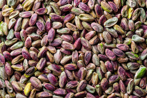 Pile pistachio kernels nuts without shell, closeup. Pistachios without shell, top view. Whole nut kernels