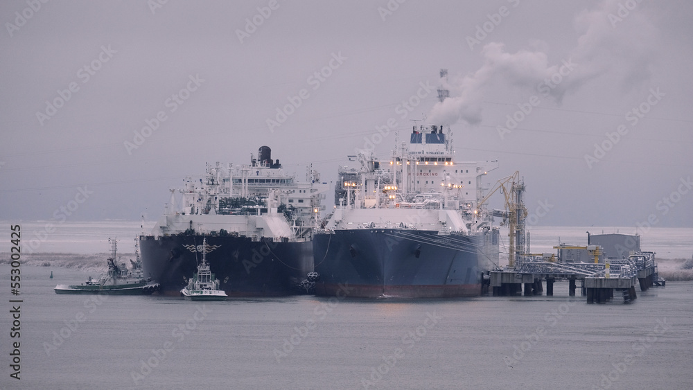 Floating storage and regasification unit and liquified natural gas carrier in the port during the ship-to-ship operations Floating storage and regasification unit and liquified natural gas carrier in the port during the ship-to-ship operations